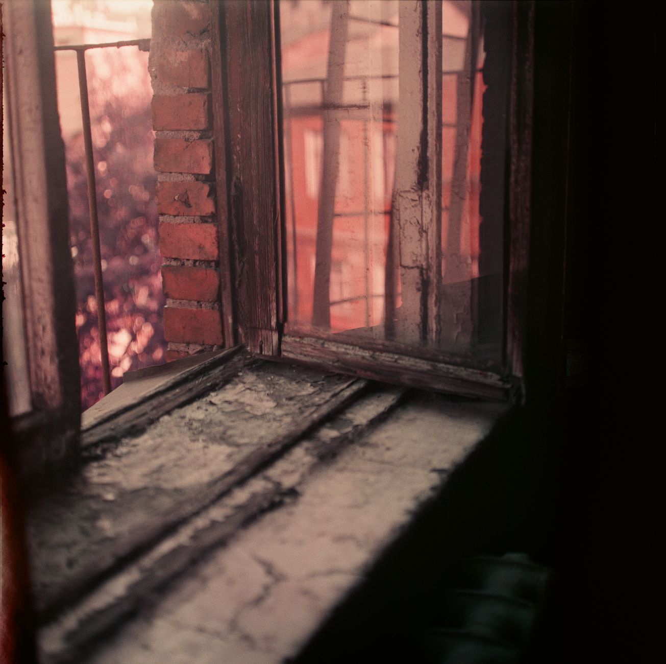 A mystical open window with wooden frame and brick wall evoking a vintage, moody ambience