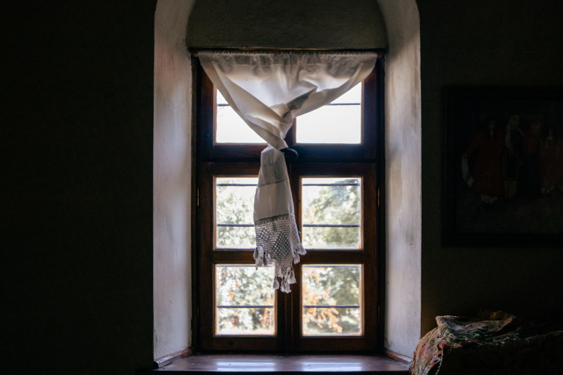Charming window with sunlight streaming through vintage curtains in Elazığ, Türkiye